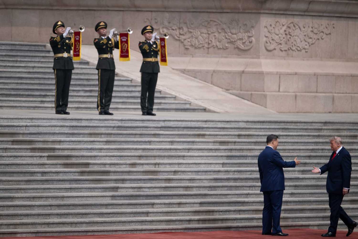 U.S. President Donald Trump (R) shakes hands with China's President Xi Jinping during a welcome ceremony at the Great Hall of the People in Beijing on May 14, 2026.