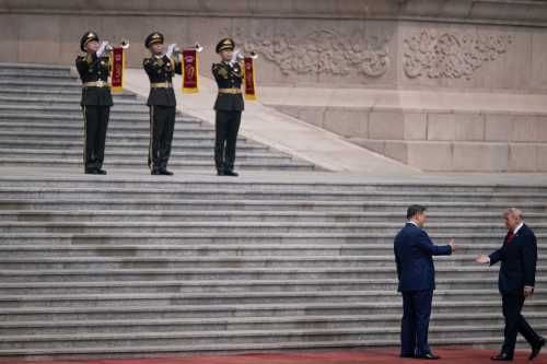 U.S. President Donald Trump (R) shakes hands with China's President Xi Jinping during a welcome ceremony at the Great Hall of the People in Beijing on May 14, 2026.