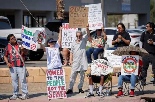 Demonstrators wave signs during a nationwide protest against AI data center expansion in Imperial, California on July 18, 2026.