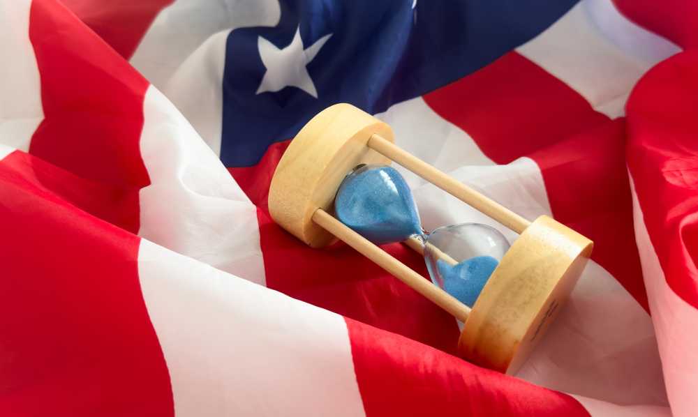 Hourglass sitting atop American flag