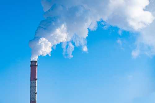 Smokestack against blue sky