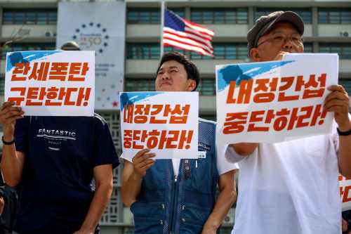 A member of a South Korean civic group delivers a speech during a press conference denouncing the United States' unilateral tariff hikes and opposing interference in South Korea's domestic affairs, in front of the U.S. Embassy in Seoul, South Korea, on July 28, 2026.
