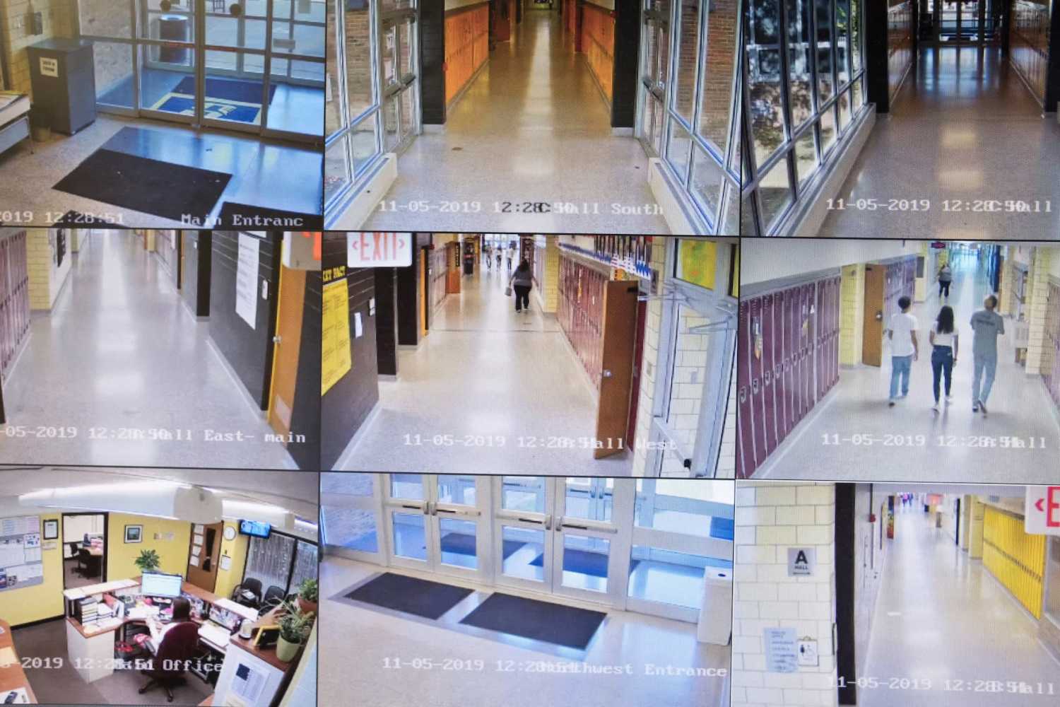Video cameras monitor the halls of Sidney High School in the attendance office of the school in Sidney, Ohio, October 31, 2019.