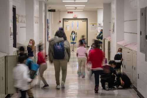 LOUISVILLE, KY - JANUARY 24: A child acting as hallway monitor watches as children move about a hallway at Carter Traditional Elementary School on January 24, 2022, in Louisville, Kentucky.