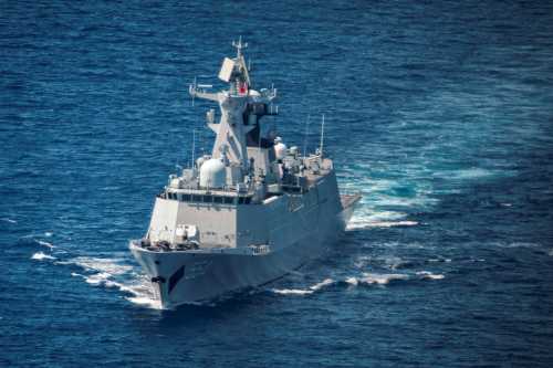 A Chinese Navy warship is seen from aboard a Philippine Bureau of Fisheries and Aquatic Resources (BFAR) plane on June 15, 2026 in Scarborough Shoal, South China Sea.
