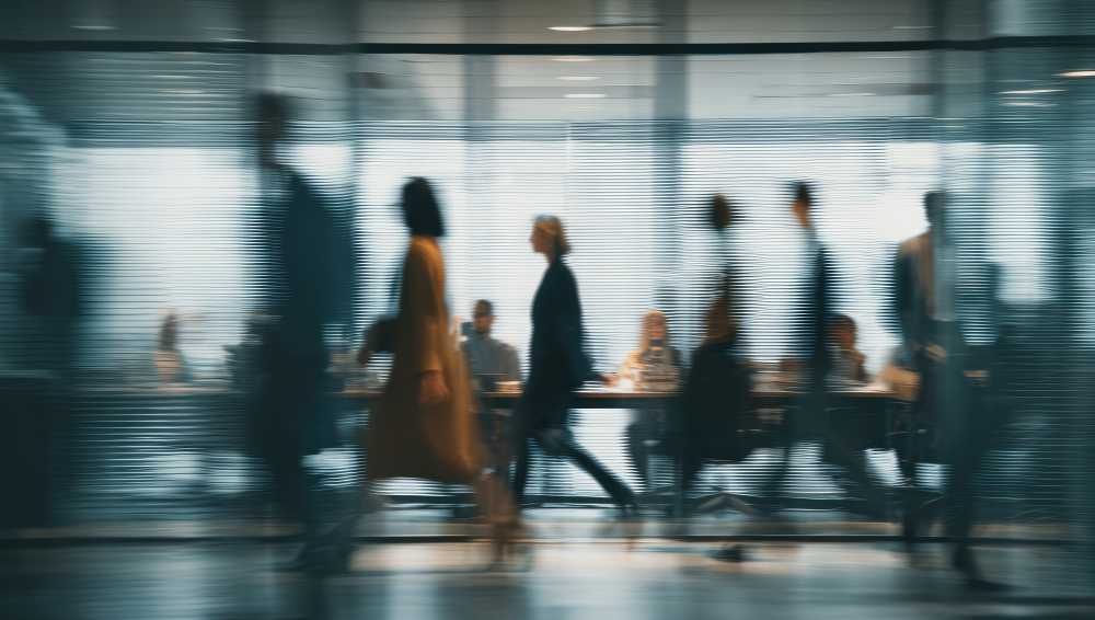 Blurred motion view of office employees walking