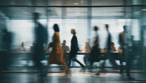 Blurred motion view of office employees walking