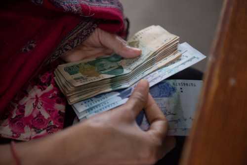 A woman counts cash