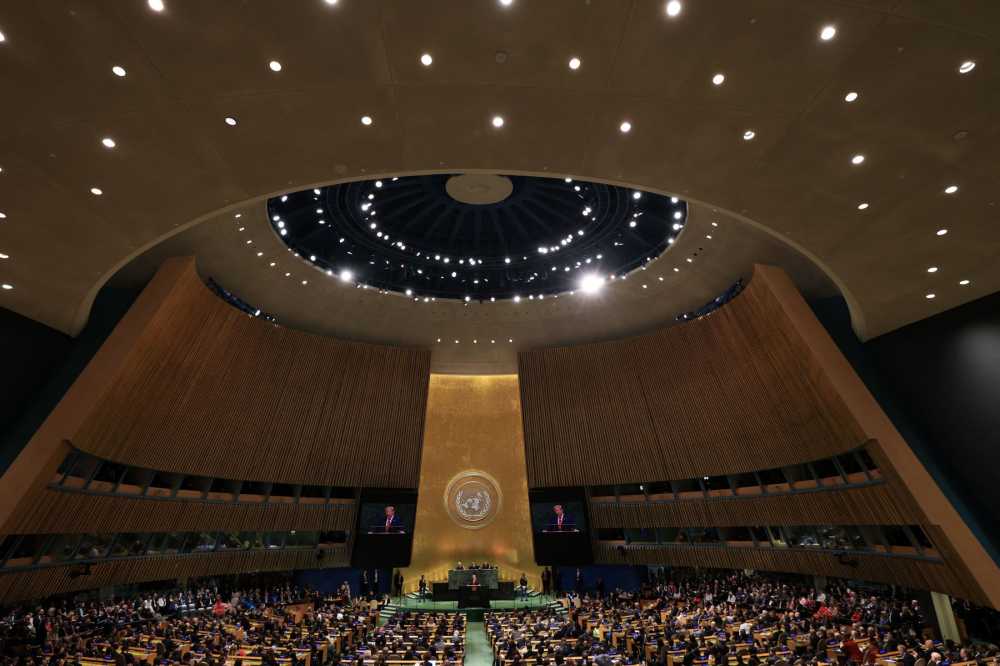 Wide view of the General Assembly Hall at the United Nations with seats filled while President Trump delivers remarks at the podium