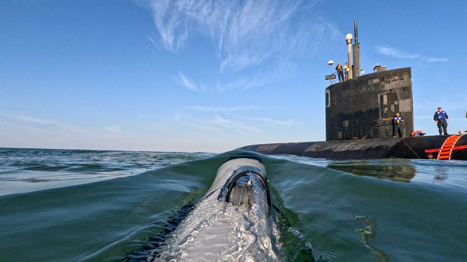 Operationally integrating proven robotic systems for routine use by commanders, a small unmanned undersea vehicle (UUV) assigned to Undersea Unmanned Vehicle Group One, Detachment Little Creek, approaches the Los Angeles-class fast-attack submarine USS Hampton (SSN-767).