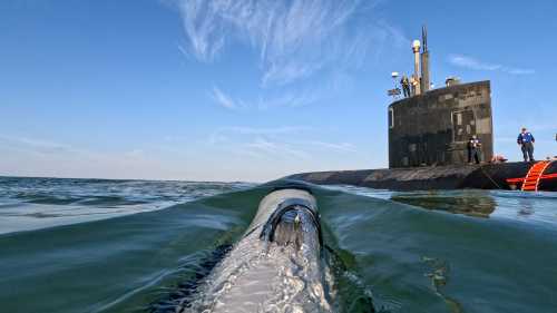 Operationally integrating proven robotic systems for routine use by commanders, a small unmanned undersea vehicle (UUV) assigned to Undersea Unmanned Vehicle Group One, Detachment Little Creek, approaches the Los Angeles-class fast-attack submarine USS Hampton (SSN-767).