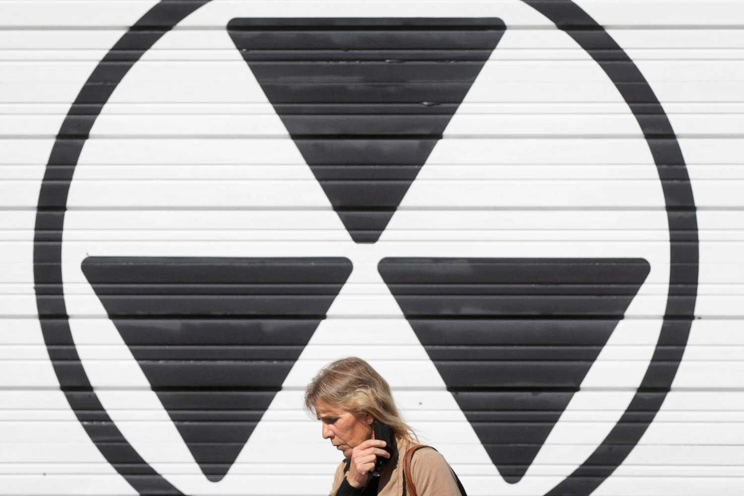 A person walks past a nuclear fallout sign outside the Diefenbunker, Canada's Cold War Museum, in Ottawa on October 5, 2022.