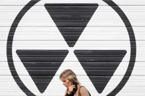 A person walks past a nuclear fallout sign outside the Diefenbunker, Canada's Cold War Museum, in Ottawa on October 5, 2022.