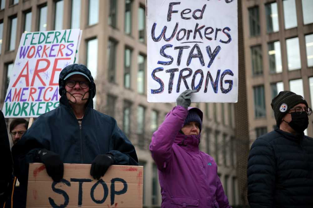 WASHINGTON, DC - FEBRUARY 05: Protesters rally outside of the Theodore Roosevelt Federal Building headquarters of the U.S. Office of Personnel Management on Feb. 5, 2025, in Washington, D.C. The group of federal employees and supporters are protesting against Elon Musk, tech billionaire and head of the Department of Government Efficiency (DOGE), and his aides who have been given access to federal employee personal data and have allegedly locked out career civil servants from the OPM computer systems.