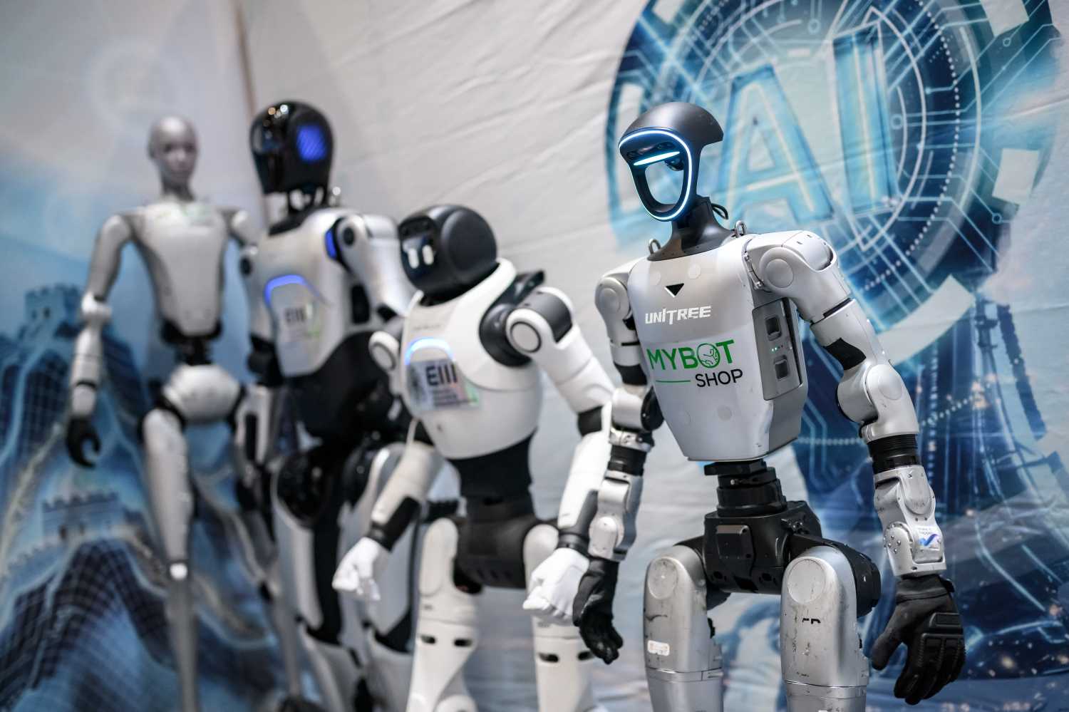 This photograph shows humanoid robots on display at the booth of Chinese technology companies during the AI for Good Global Summit, a United Nations flagship event aimed at shaping the future of artificial intelligence, in Geneva, Switzerland, July 7, 2026.