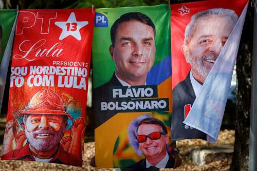Towels and caps for sale depicting Brazilian presidential candidates Luiz Inacio Lula da Silva and Flavio Bolsonaro are seen in a residential area of Brasília on September 11, 2026. Brazil will hold a presidential elections on October 4, 2026.