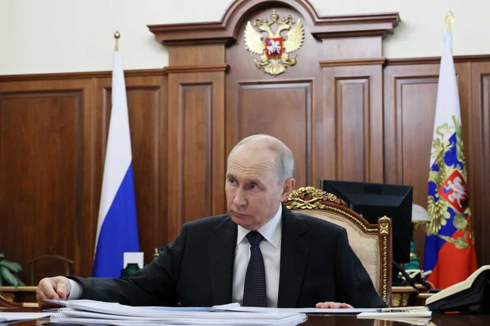 In this pool photograph distributed by the Russian state agency Sputnik, Russia's President Vladimir Putin attends a meeting with the governor of Novgorod region in Moscow on September 14, 2026.
