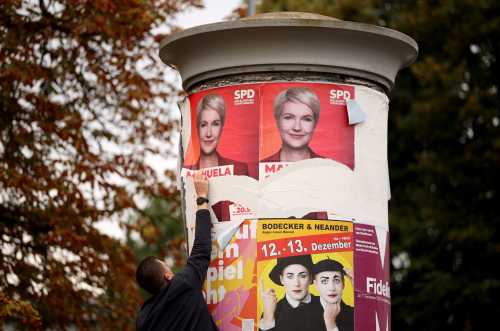 A man removes an election poster of Mecklenburg-Western Pomerania's State Premier and top candidate of the social democratic SPD party Manuela Schwesig in front of the polling station where the candidate of the far-right Alternative for Germany (AfD) is expected to cast his ballot, in accordance with a rule stating that no campaign advertising is permitted in front of polling places on election day, on September 20, 2026 in Schwerin.
