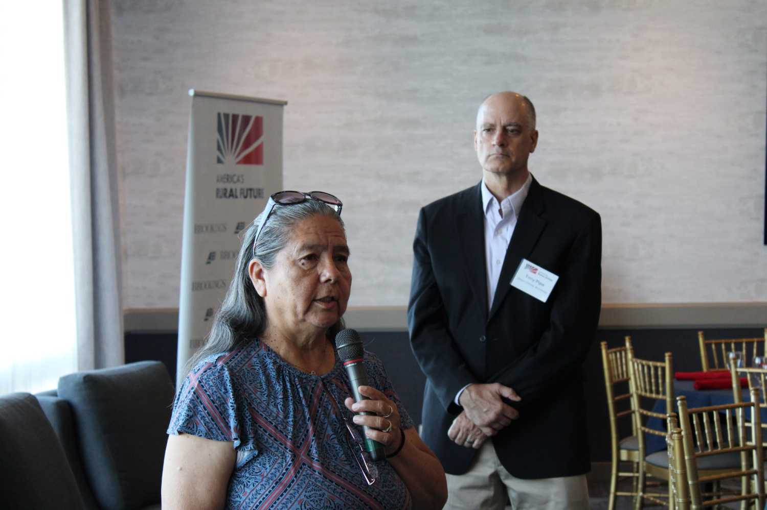 Frances Charles, former chairwoman of the Lower Elwha Klallam Tribe, addresses the Commission on its arrival in Port Angeles, as Tony Pipa looks on.