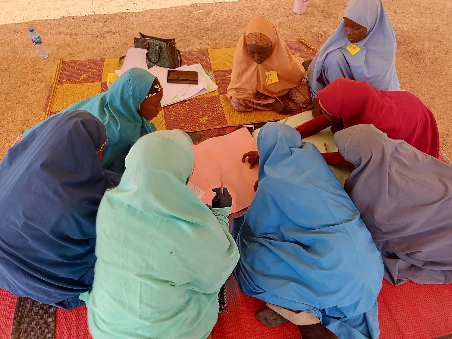 Girls in Kano, Nigeria engage in community mapping exercise as part of LAAGA research. Photo credit: Isa Wali Empowerment Initiative.