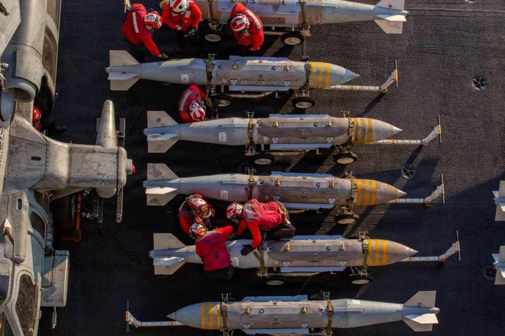 In this U.S. Navy released handout, U.S. Sailors prepare to stage ordnance on the flight deck of Nimitz-class aircraft carrier USS Abraham Lincoln (CVN 72) in support of Operation Epic Fury on February 28, 2026 at Sea.