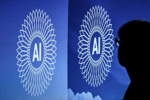 A person is silhouetted next to the logo of the first Global Dialogue on AI Governance, in Geneva on July 6, 2026. Guterres called for a global governance system to shape artificial intelligence for the good of humanity, warning against allowing the technology itself to "vibe-code" our future.  (Photo by Fabrice COFFRINI / AFP via Getty Images)