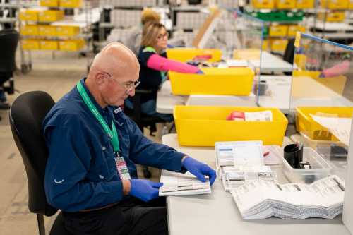 RENTON, WASHINGTON - OCTOBER 23: An election worker opens midterm elections ballots at the King County Elections headquarters on Oct. 23, 2026, in Renton, Washington.