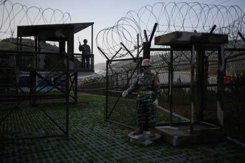 Mannequins of South Korean soldiers stand before a guard post open to visitors, beside the barbed wire fence of the Demilitarized Zone (DMZ) between North and South Korea on Ganghwa island on May 24, 2018.