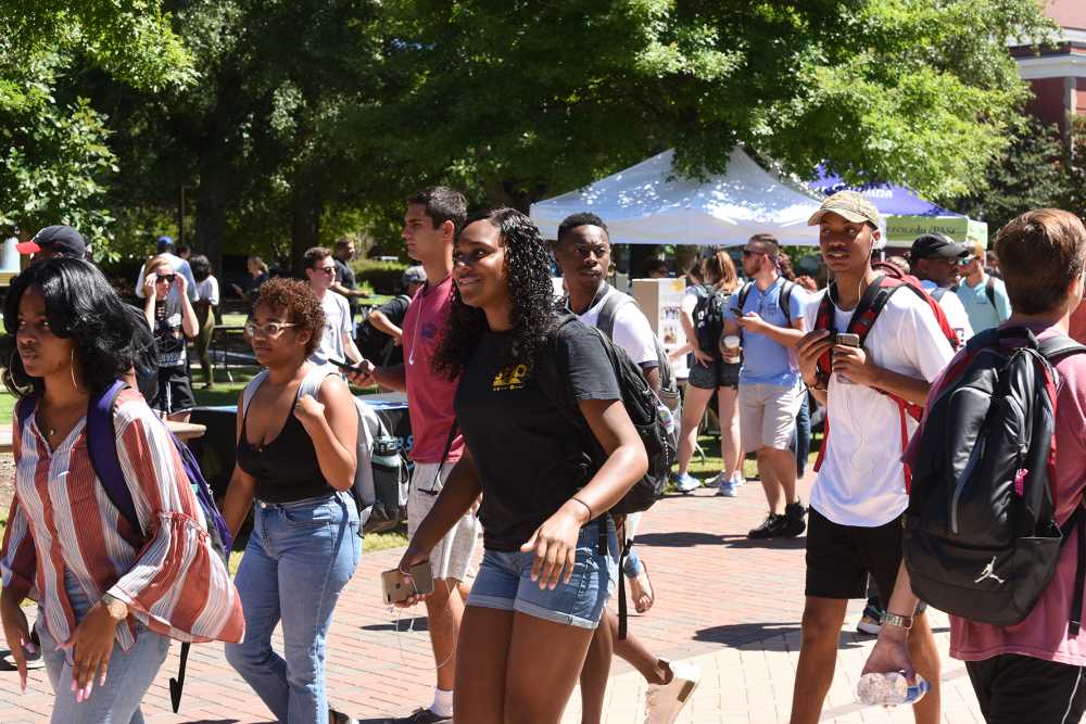 Greenville, North Carolina/United States- 08/30/2018: A group of African American college students walk across campus between classes.