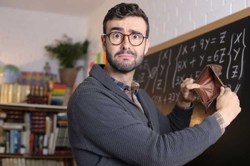 teacher holds up an empty wallet